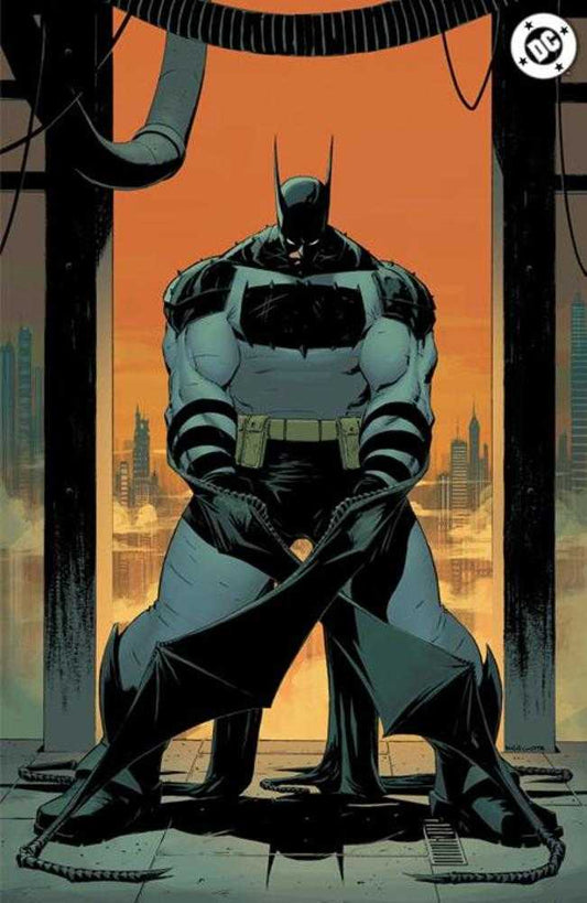 Comic art of muscular Batman in a gray and black costume with a utility belt, cape folded on the ground. He's standing in front of an orange cityscape. Overhead pipes and a DC Comics logo are visible.