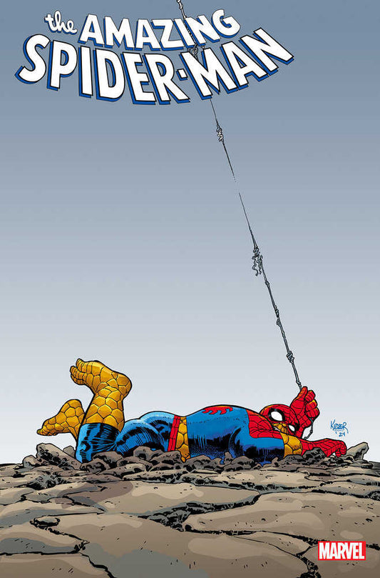 Comic book cover art featuring Spiderman lying face down in cracked earth while holding a web.