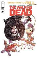 Comic book cover for "The Walking Dead: Something to Fear, Part Four", featuring an angry man with a bat striking a piñata.