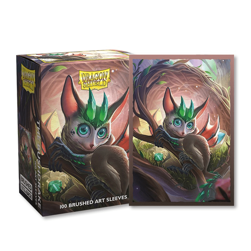 Box and playing card sleeve featuring a drawing of an animal sitting in a tree.