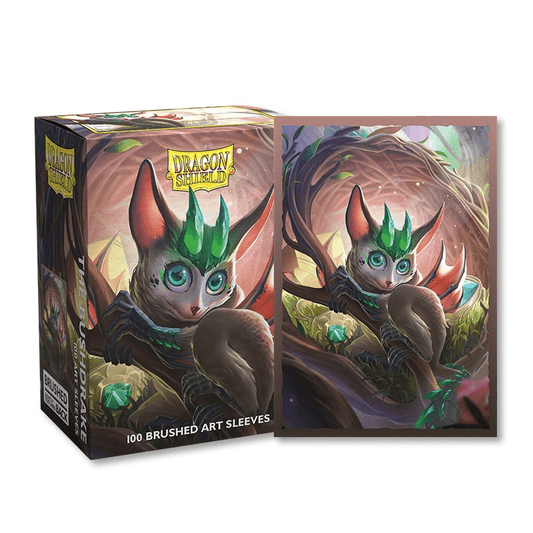 Box and playing card sleeve featuring a drawing of an animal sitting in a tree.
