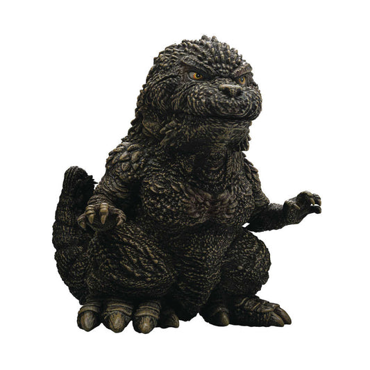 A Godzilla figure sitting with raised arms.