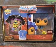 Here is a descriptive alt tag for the image:

Funko POP! boxed set featuring a Masters of the Universe t-shirt with cartoonish characters and a Ram Man vinyl figure.
