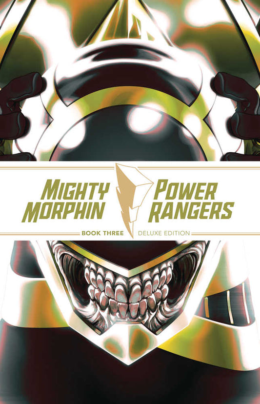 Comic book cover featuring two stylized, close-up views of Power Rangers helmets in white, yellow, and black. The title "Mighty Morphin Power Rangers Book Three Deluxe Edition" is centered between the helmets.