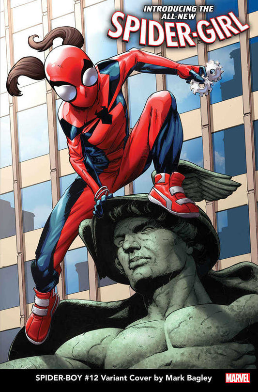 Spider-Girl on a statue against a building, red suit, gear in hand.