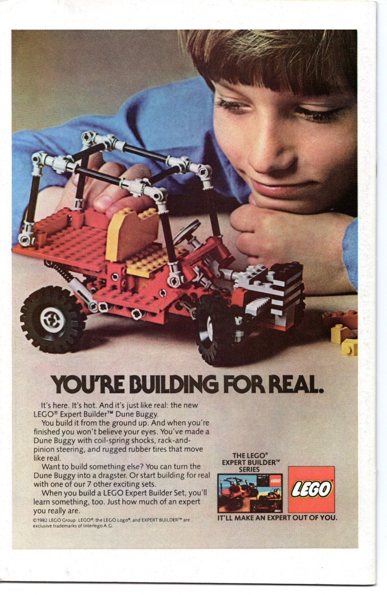 A boy admires a red Lego dune buggy in an advertisement.