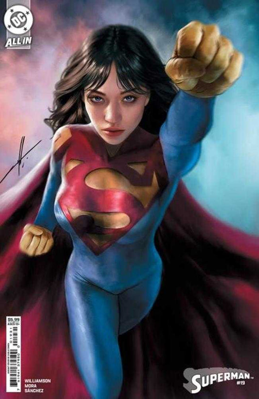 Comic book cover featuring a woman in a blue Superman suit with a red and yellow shield emblem, cape, and fists raised.